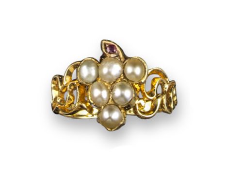 A 19th century fruiting vine ring, set with seed pearls and a cushion-shaped ruby, with glazed locket compartment to the reve