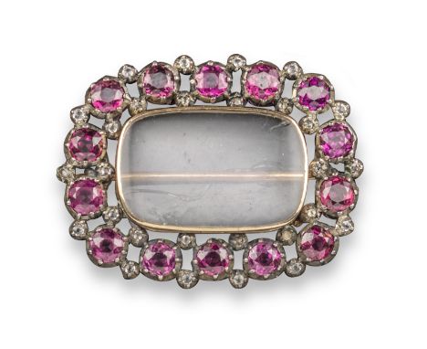 An early 19th century garnet and diamond locket brooch, the vacant locket compartment set within a surround of circular-cut g