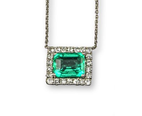 An emerald and diamond pendant, the step-cut emerald weighs 3.39cts, set within a surround of round brilliant-cut diamonds in