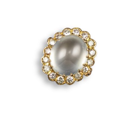 A jade and diamond cluster ring, the ice jade cabochon is set within a surround of circular-cut diamonds in yellow gold, size