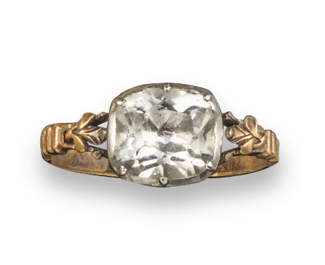 A George III rock crystal-set ring, the cushion-shaped rock crystal is set in silver on gold closed-back setting, with foliat