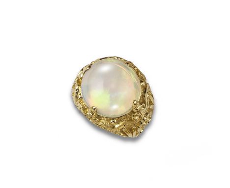 An opal set gold bombe ring, the circular opal cabochon is claw set in elaborately decorated gold ring, size O