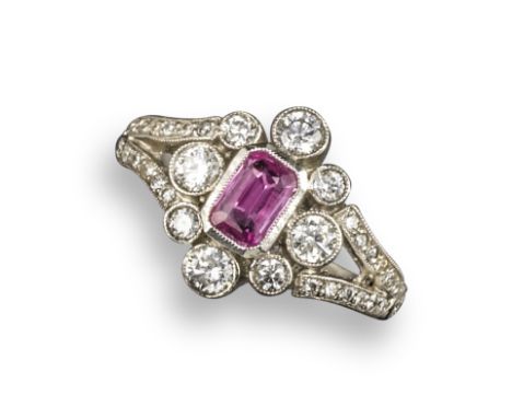 A pink sapphire and diamond cluster ring, centred with an emerald-cut pink sapphire within quatrefoil surround of circular-cu