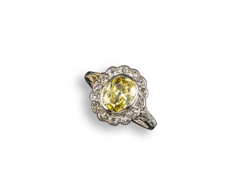 A fancy diamond cluster ring, centred with an oval-shaped fancy vivid yellow diamond weighing 1.17cts and set in a surround o