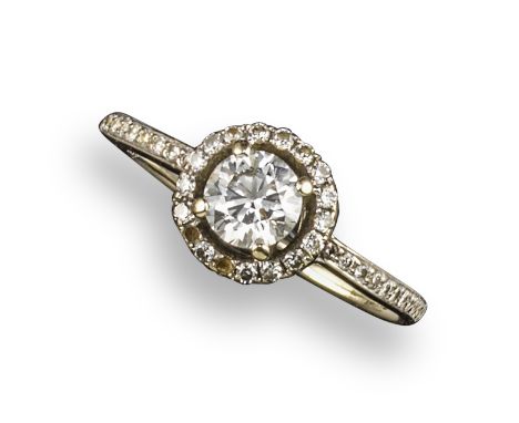 A diamond cluster ring, the round brilliant-cut diamond set within a surround of circular-cut diamonds (two stones missing), 