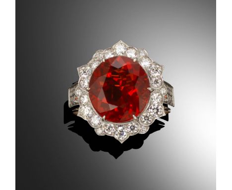 A fire opal and diamond cluster ring, the oval-shaped fire opal set within scallop-edged diamond-set white gold mount and dia