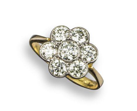 A diamond cluster ring, of flowerhead design, set with round brilliant-cut diamonds in platinum and yellow gold, size O 1/2