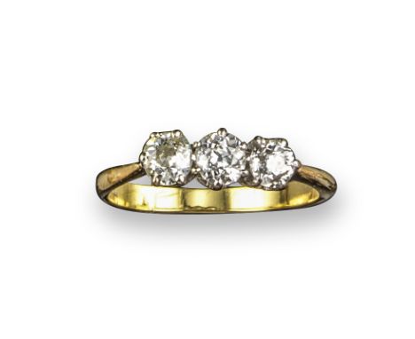 A diamond three-stone ring, set with graduated old cushion-shaped diamonds in platinum and gold, size Q 1/2