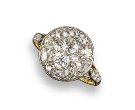 A diamond target ring, the centre section pave-set with old circular and cushion-shaped diamonds in silver on gold, with rose