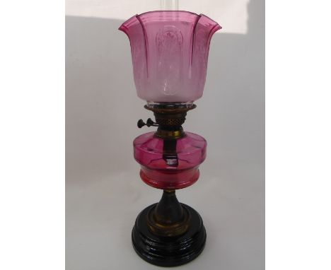 An Antique Cranberry Glass Oil Lamp, the lamp having etched glass shade, total ht 57 cms.