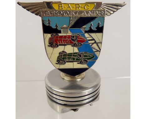 A Vintage Enamel and Chrome BARC (Brooklands Automobile Racing Club Badge), mounted on a cylindrical plinth, nr 1095.With a c
