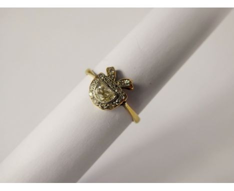 An Art Nouveau 18 ct Yellow Gold Crescent Cut Diamond Ring, the central diamond measuring 3 x 5 mm, in a bow mount with old c