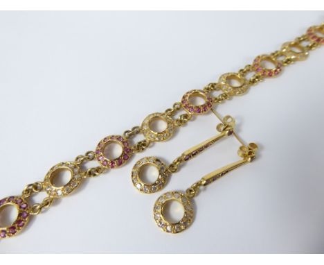 An 18 ct Diamond and Ruby Bracelet and Earrings, earrings approx 24 pts of 8 cut dias each earring and the bracelet approx 1.