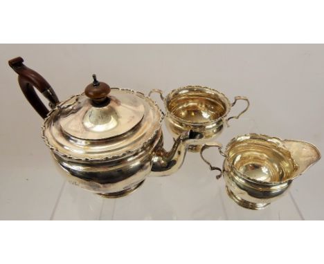 A Silver Tea Trio, comprising teapot, milk jug, sugar bowl, Birmingham hallmark, mm Adie Bros Ltd, approx 560 gms.