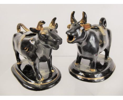 Two Black Ceramic Cow Creamers.