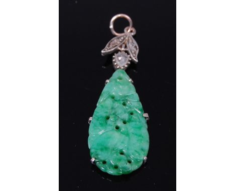 A late 19th century Chinese jade carving of pendant shape, in European white metal mount, the whole surmounted with three rou