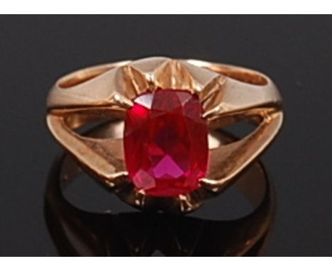 A modern 14ct gold ruby dress ring, the oval cut claw set ruby weighing approx 2ct, 7.5g, size N