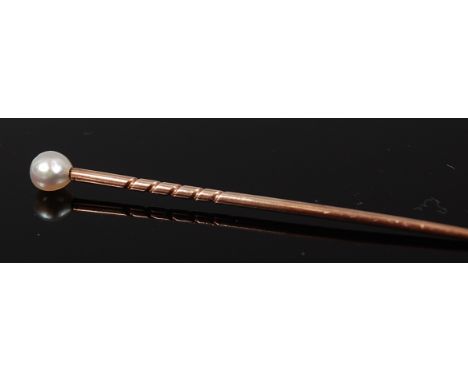 A circa 1900 yellow metal and pearl topped tie-pin, unmarked but tests as 9ct gold, 1.1g, 5.7cm