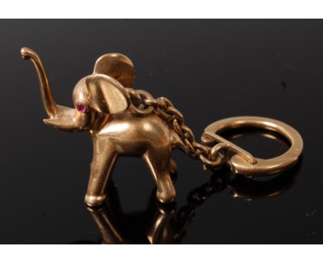 A 9ct gold novelty pendant on key chain, modelled as an elephant cub, having ruby set eyes, gross weight 26.9g, h.3.1cm