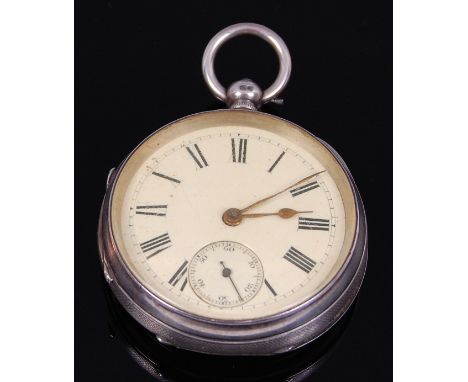 A late Victorian silver cased gents open faced pocket watch, having an engine turned case, unsigned white enamel dial with su