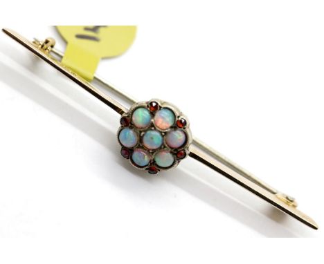 Ladies antique 9ct gold opal seven stone daisy cluster brooch, L: 5 cm, 3.2g. P&amp;P Group 1 (£14+VAT for the first lot and 