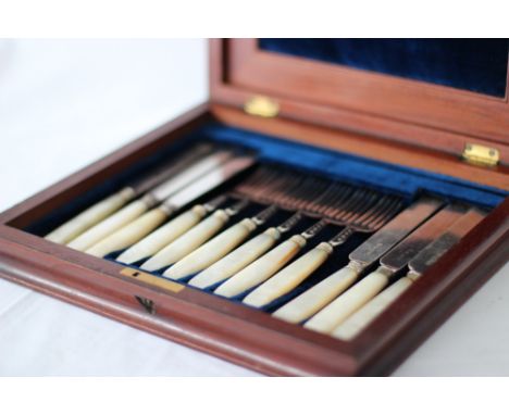 A Boxed Set of 6 Knives and Forks with Mother of Pearl Handles