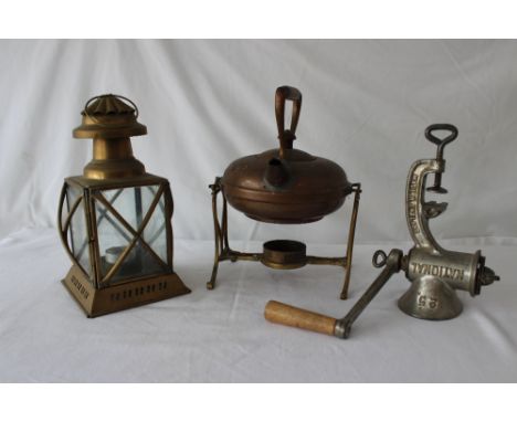 A vintage meat grinder, lantern and brass kettle