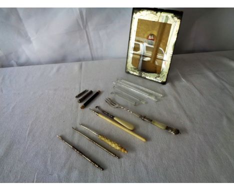 A collection of glass swizzle sticks, button hooks, sweetmeat fork and other items and a picture frame