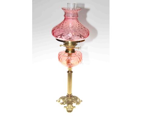 Victorian brass column oil lamp with ruby glass reservoir and shade