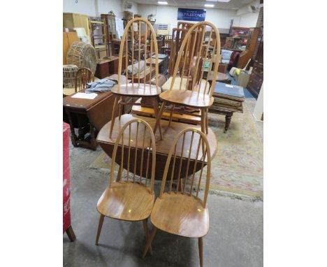 AN ERCOL STYLE DROPLEAF TABLE WITH FOUR HOOPBACK CHAIRS