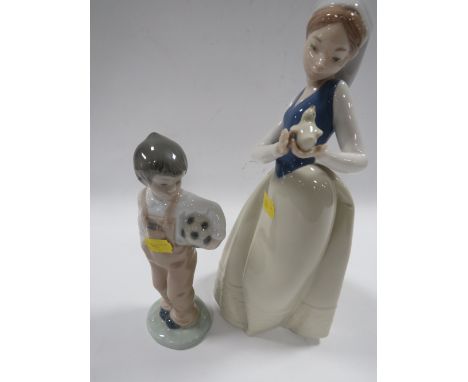 A NAO FIGURE OF A GIRL HOLDING A BIRD TOGETHER WITH A SMALL NAO FIGURE OF A BOY HOLDING A FOOTBALL