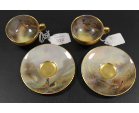 A PAIR OF ROYAL WORCESTER 'PHEASANT' CABINET CUPS AND SAUCERS - SIGNED J.A. STINTON C1921