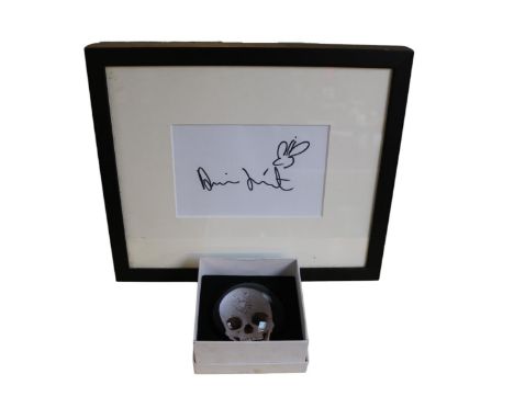 Damien Hirst b.1965 Signature on paper framed and a boxed Paperweight For the Love of God?