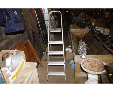 An aluminium step ladder and a lawn aerator