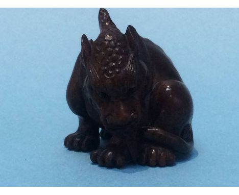 A carved netsuke in the form of a dog of Fo