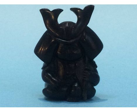 A carved netsuke in the form of a child