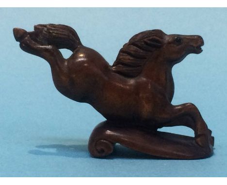 A carved netsuke in the form of a horse