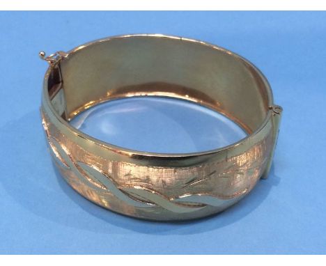A gold bangle stamped '750', 39.8 grams