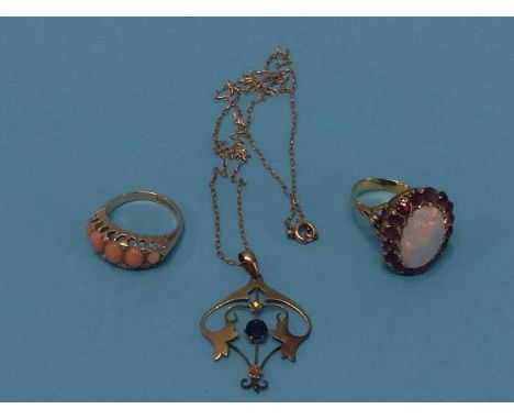 A 9ct Art Nouveau pendant, a 9ct coral mounted dress ring and a gold coloured opal mounted ring