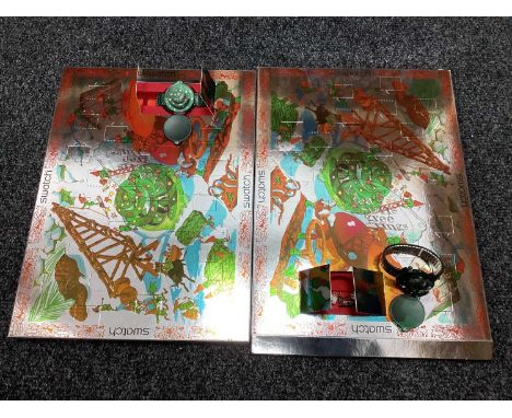 Swatch; Two 1997 Advent Calendars, each with watch and assorted charms.