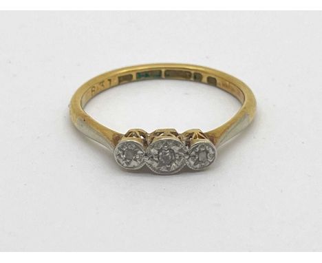 A Dainty Vintage Three Stone Diamond Ring, illusion set, stamped "18ct" "Plat" (finger size M1/2) (2grams).