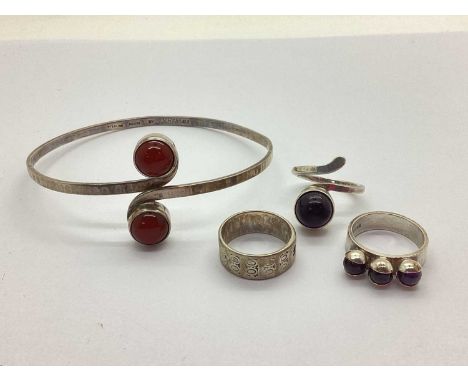 A Stone Set Crossover Bangle, the collet set stones to uniform planished band, stamped "STERLING SILVER by S.BEDDALL; Three H