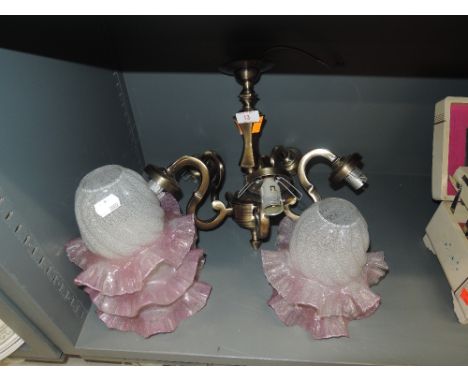 A ceiling light shade with pink and frosted glass 