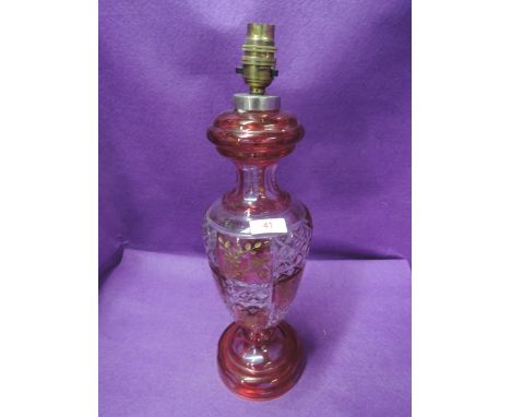 A 20th century ruby and clear glass table lamp having gilt heightened leaf decoration