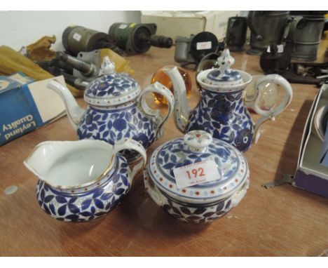 A ceramic tea service hand decorated in cobalt and gilt