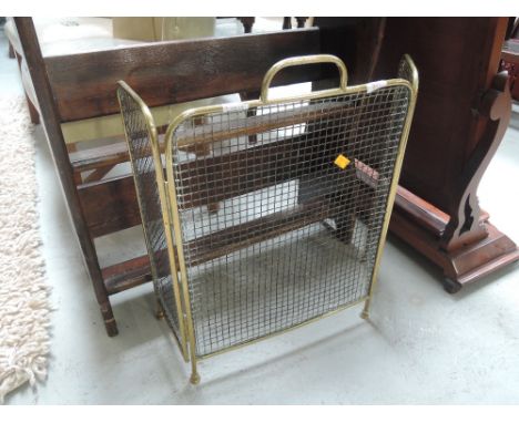 An Edwardian brass tri fold mesh fire screen
