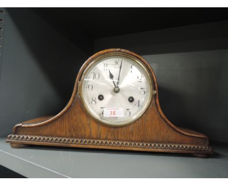 An antique mantle clock with chime in a napoleon design