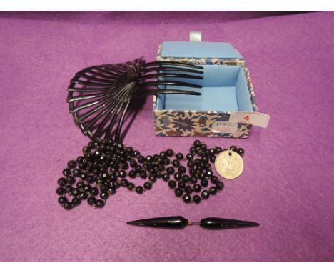 A small selection of black mourning jewellery including large hair comb, Dott brooch (AF) string of beads etc