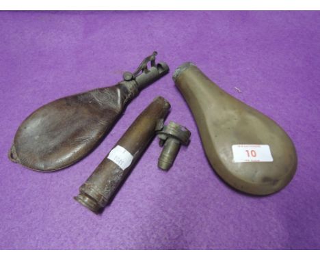 A selection of gun and shooting related items including shot flask