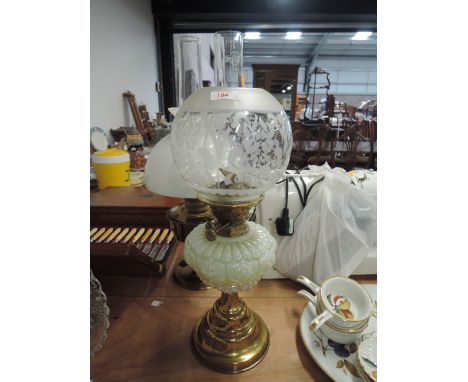 A Victorian vaseline glass well oil burning lampRESERVOIR SEEMS OK, LIGHT MARKS TO SHADE WHICH IS PROBERLY NOT ORIGINAL